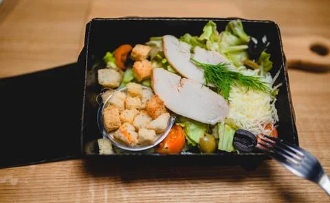 Caesar salad with chicken in lunchbox Stock Photos