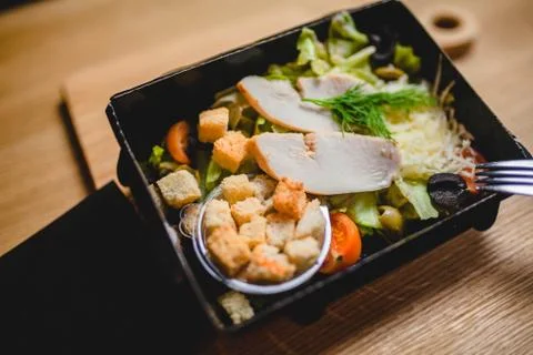 Caesar salad with chicken in lunchbox Stock Photos