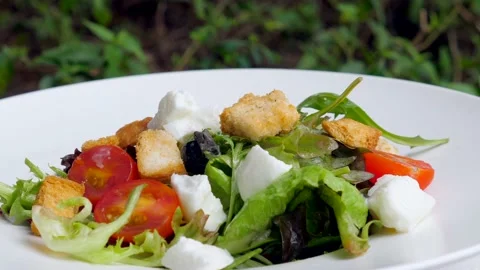 Caesar salad with chicken, mozzarella, and cherry tomatoes served at outdoor Stock Footage 236858277