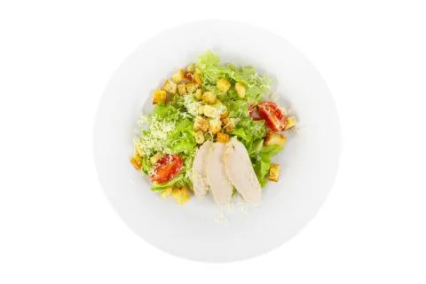 Caesar salad with chicken on plate white isolated Stock Photos