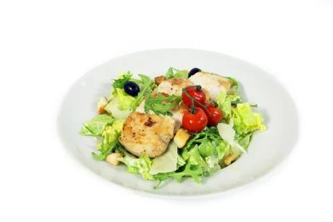 Caesar salad with chicken steak on white background Stock Photos
