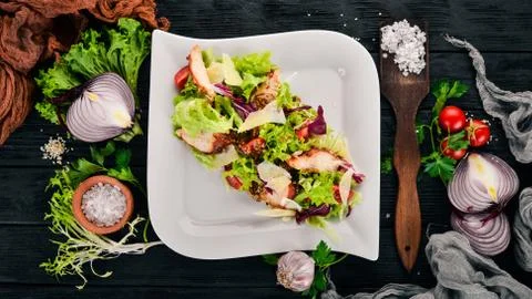 Caesar salad with chicken. Top view. On a wooden background. Copy space. Stock Photos