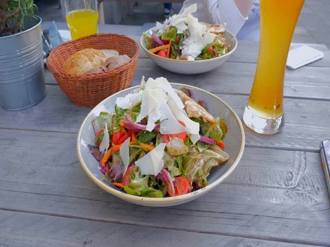 Caesar salad closeup camera backwards fly follow falling croutons Stock Footage 82649922