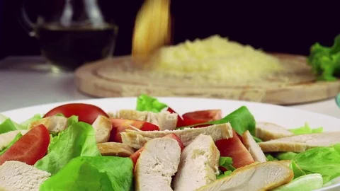 Caesar salad. Cook adds croutons in a salad Stock Footage 74225796