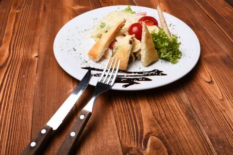 Caesar salad with dressing and parmesan on top Stock Photos