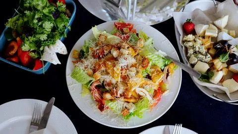 Caesar salad featuring grilled chicken, crisp croutons, shaved parmesan, and Stock Photos