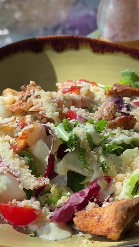Caesar salad Fresh mixed salad with sesame seeds rotating slowly in sunlight Stock Footage 318077255