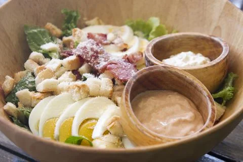 Caesar salad on the garden table Фото