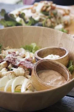 Caesar salad on the garden table Stock Photos