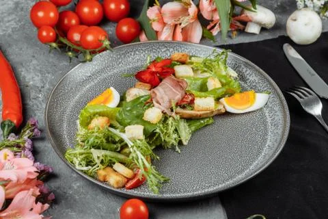 Caesar salad on a gray plate with decor and copyspace Stock Photos