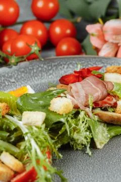 Caesar salad on a gray plate with decor and copyspace Stock Photos