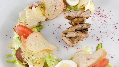 Caesar salad with grilled chicken and crispy bread, creative design of the dish Stock Footage 94211280