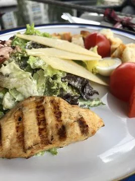 Caesar salad with grilled chicken macro Stock Photos