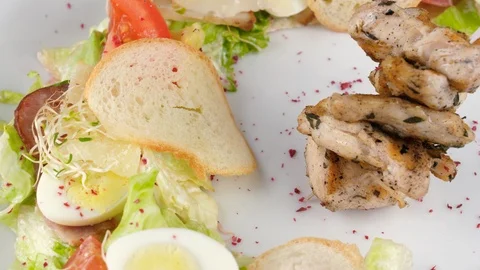 Caesar salad with grilled chicken, served in restaurant, close-up view Stock-Footage 94211308