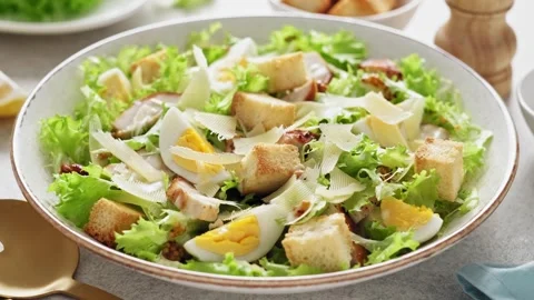 Caesar salad with lettuce, croutons, eggs, and grilled chicken breast Stock Footage 274072338