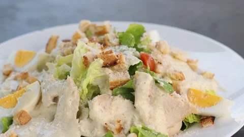 Caesar salad with parmesan cheese, grilled chicken and eggs. Stock Footage 234086200