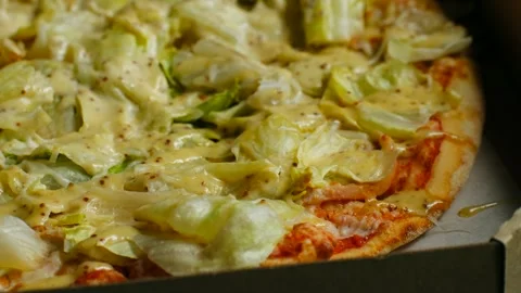 Caesar salad pizza with lettuce and mustard dressing close up Stock Footage 311754162