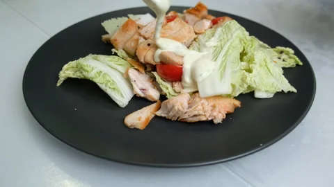 Caesar Salad on Plate. Black Plate. Vegetables and Meat. Cherry Tomatoes Stock Footage 147168056