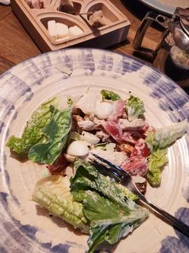 Caesar salad on a plate in a restaurant with an egg Stock Photos