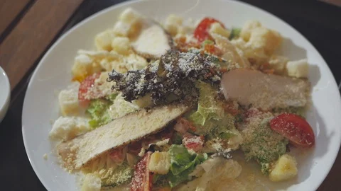 Caesar salad in a plate on the table in a restaurant Stock Footage 103578333