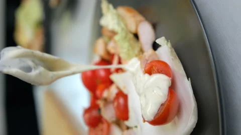 Caesar Salad on Plate. Vertical Video. Chef Adds Thick Sauce to Cherry Tomatoes Stock Footage 147346096