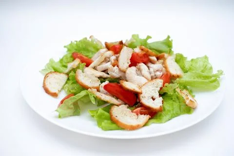 Caesar salad in a plate on a white background Foto stock