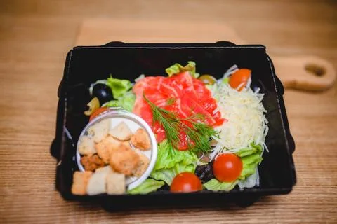 Caesar salad with red fish, crackers, tomatoes and cheese Stock Photos