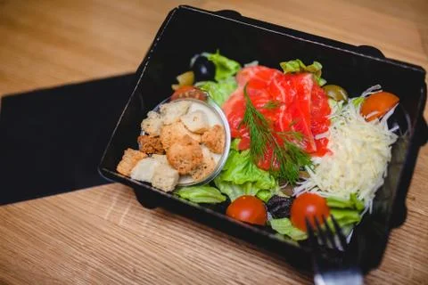 Caesar salad with red fish, crackers, tomatoes and cheese Stock Photos