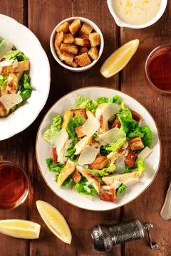 Caesar salad a rustic wooden table with wine Stock Photos