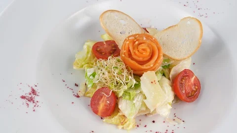Caesar salad with salmon, crispy bread and parmesan cheese, served in Restaurant Stock Footage 94256281