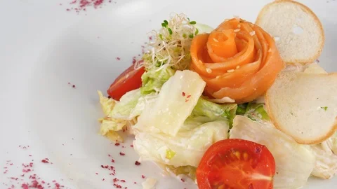 Caesar salad with salmon, parmesan cheese and crispy bread Video stock 94256395