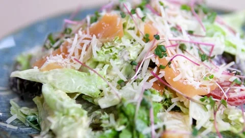 Caesar salad with salmon Traditional caesar salad in a white bowl with leaves Stock Footage 320823781