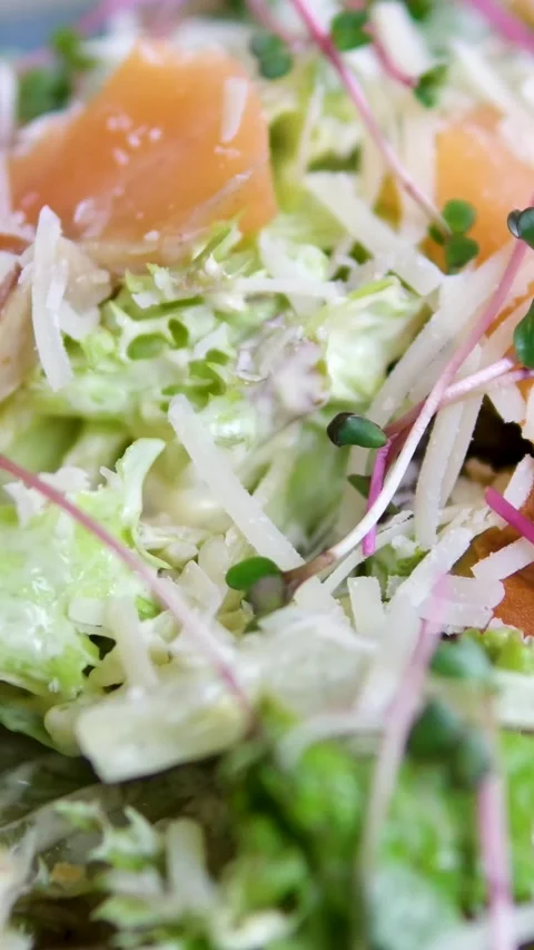 Caesar salad with salmon Traditional caesar salad in a white bowl with leaves Stock Footage 323530712