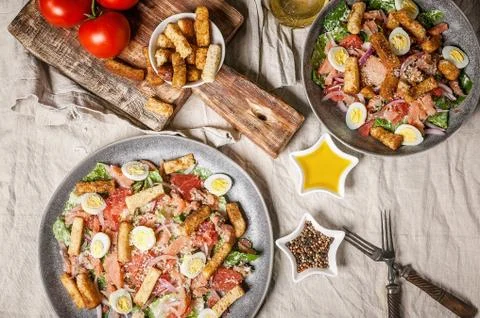 Caesar salad with salted red fish, salad romaine, quail egg and garlic crouto Stock Photos