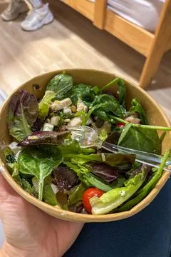 Caesar salad served in cardboard packaging Stock Photos