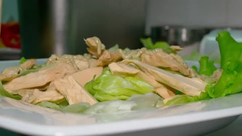 Caesar salad is served in the restaurant kitchen. Pour the sauce over the green Stock Footage 151501975