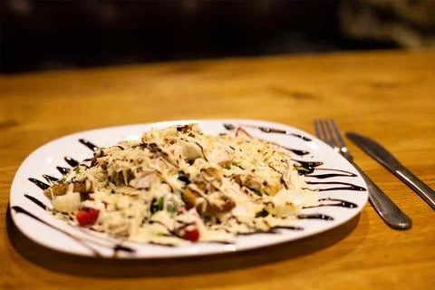 Caesar salad is served in the restaurant 스톡 사진
