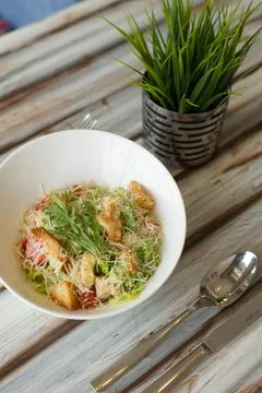Caesar salad with souce on a table Stock Photos