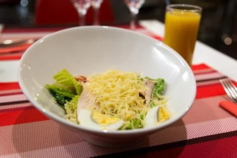 Caesar salad on table in restaurant Stock Photos