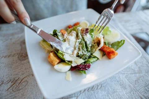 Caesar salad on table in restaurant Stock Photos