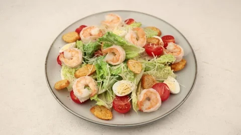 Caesar salad with tiger prawns, cherry tomatoes, croutons, parmesan cheese Stock Footage 297771868