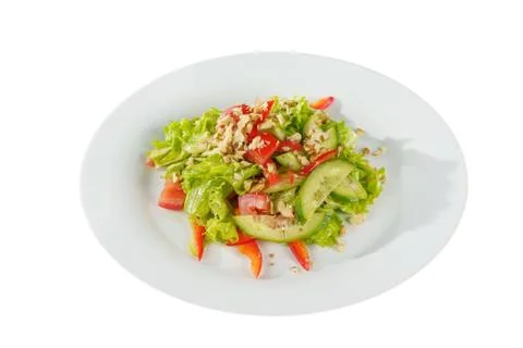 Caesar salad with walnuts on plate white isolated Stock Photos
