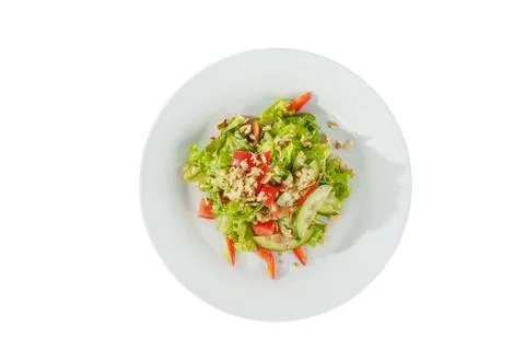 Caesar salad with walnuts on plate white isolated Stock Photos