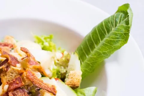 Caesar Salad on white plate, close-up Stock Photos