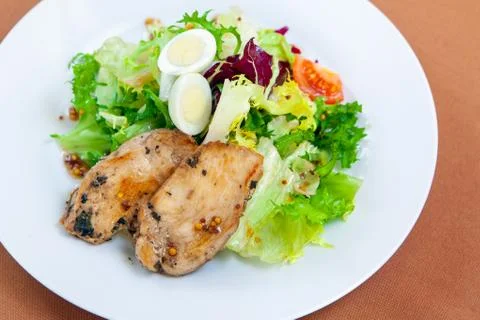 Caesar salad in white plate Stock Photos