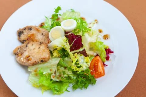 Caesar salad in white plate Stock Photos