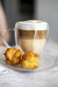 Caf Latte with chocolate chips and eclairs. Stock Photos