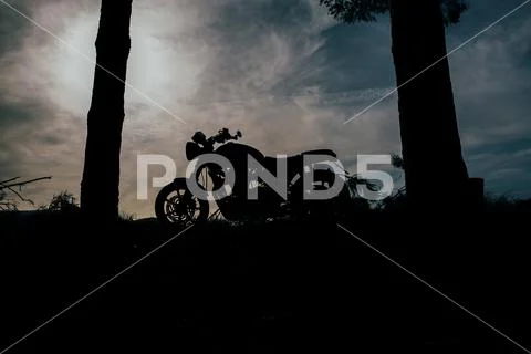 Caf racer motorbike with sunset background Stock Photos