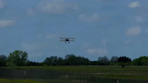 CAF Stearman Model 75 biplane trainer landing on a windy spring day in Texas Stock-Footage 154270982