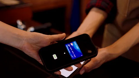 Cafe bakery worker stands on phone with QR code for payment account, custom.. Stock Footage 244969168